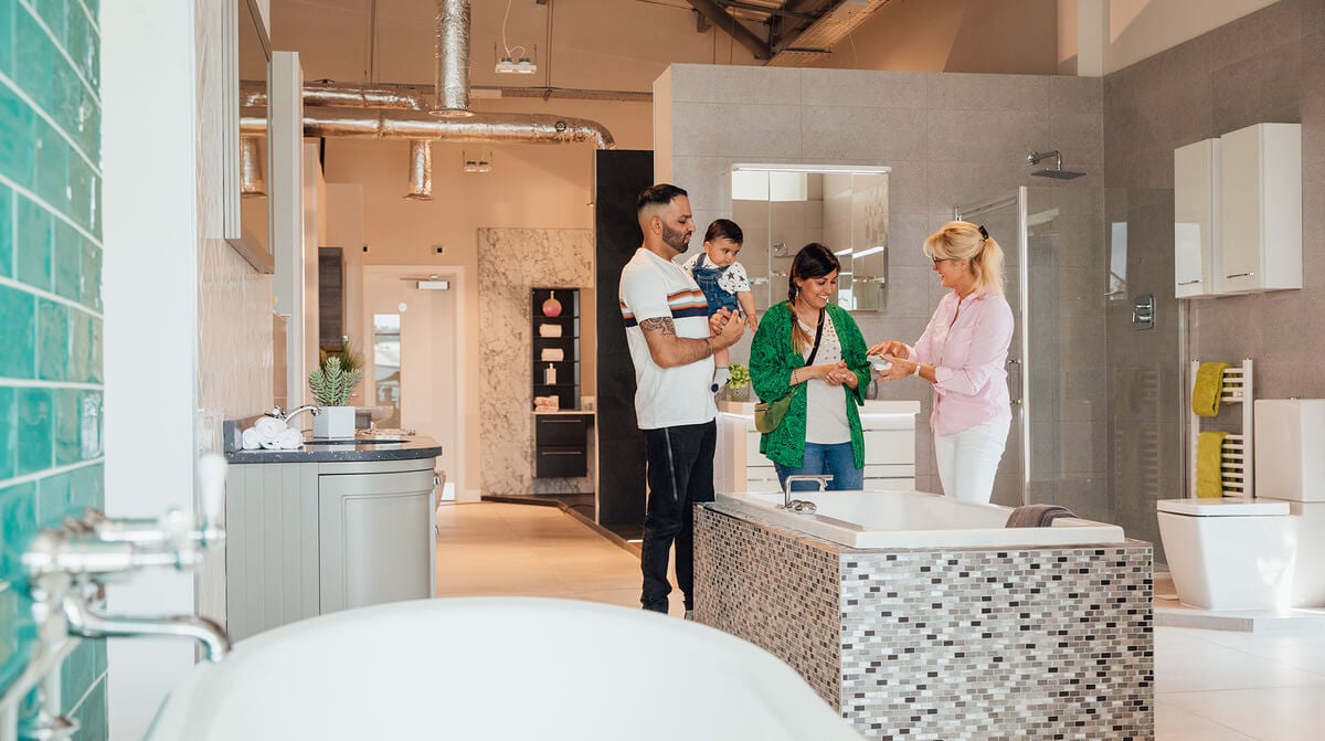 A family examines a bathroom display in a store