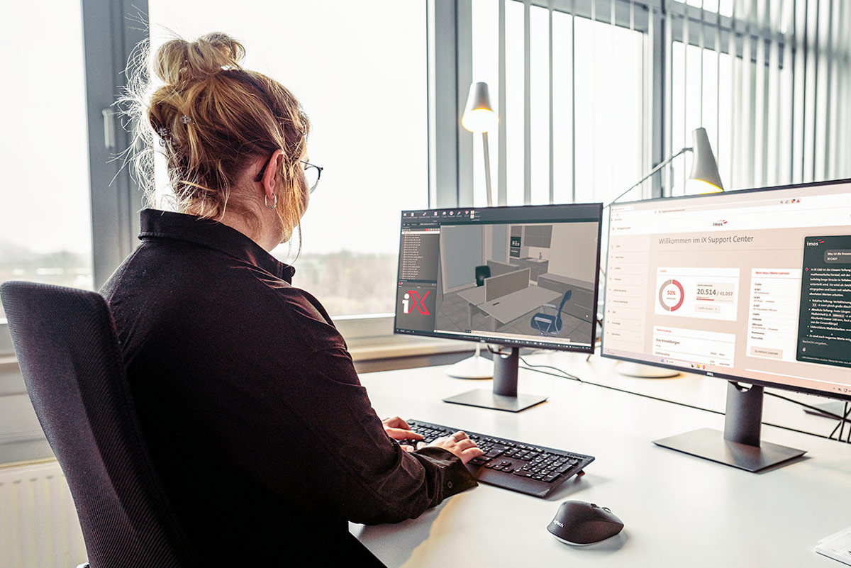 A woman working at the desktop with imos IX software