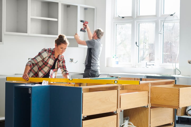 The people are installing the kitchen