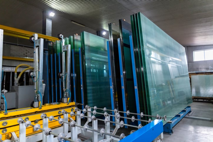 Factory for the production of double-glazed windows made of sheet glass. Sheet glass in pallets near the sheet glass cutting line