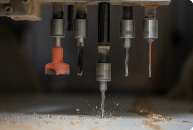 A drill is cutting through a piece of wood