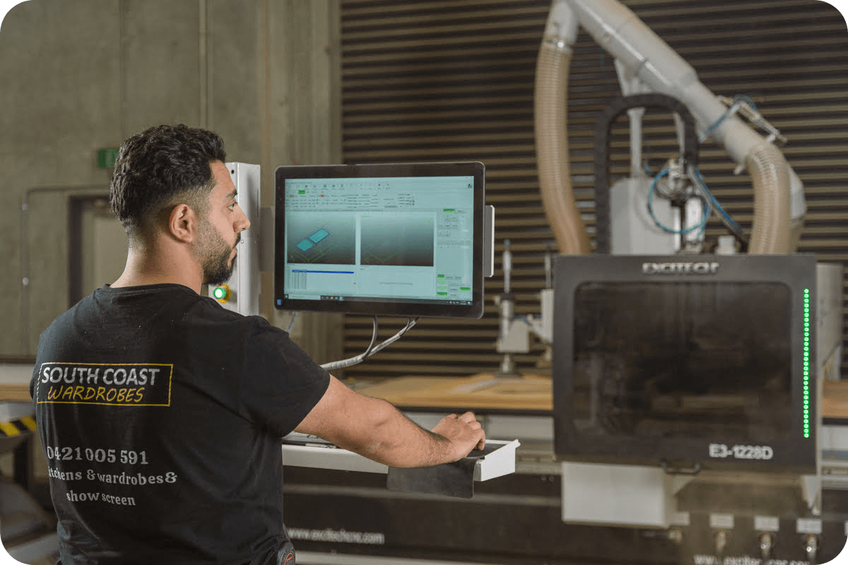 A man operates machinery in a factory setting